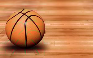basketball ball on a court - wooden floor you can see the reflection of the ball on the wood - high resolution photo not a 3d render